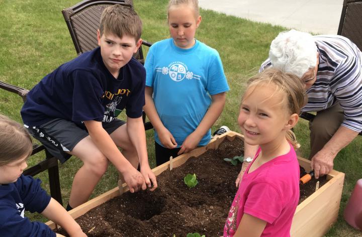 youth and volunteer planting garden